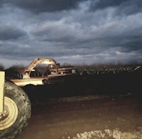 a bulldozer is working on a dirt road