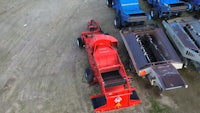 an aerial view of a group of red and blue tractor trailers