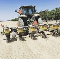 a tractor is working in a field of dirt