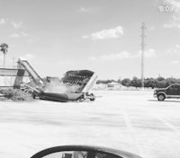 a black and white photo of a car in a parking lot